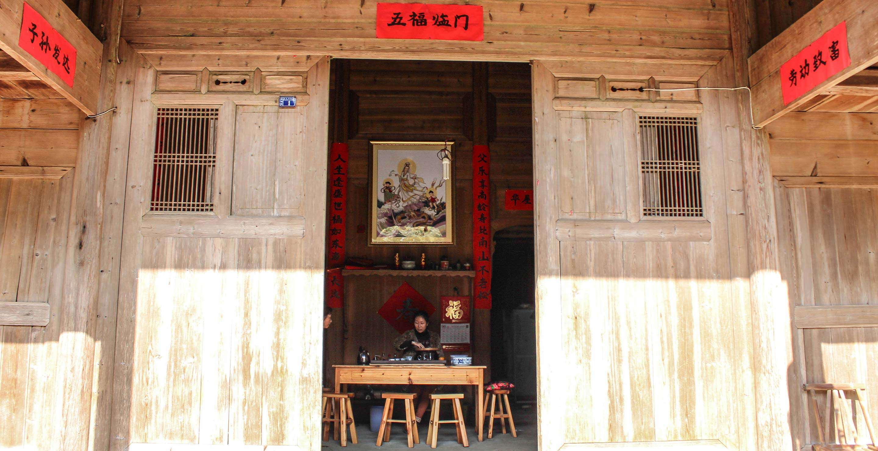 Li Xiangxi brews tea at her family's home in Tongmu