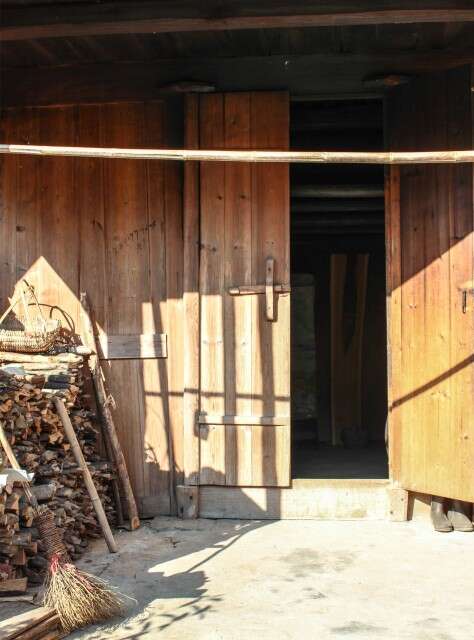 Dried wood is stacked neatly next to the room where the Li Family smokes their black tea